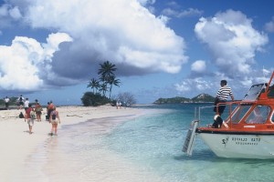 A tender decants guests on a beach in the Grenadines