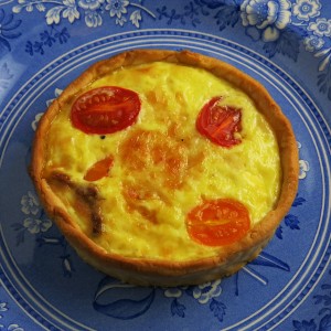 Mini quiche adorned with red and yellow cherry tomatoes