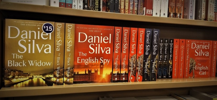 Daniel Silva books fill a shelf at a local bookstore