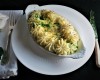 A dish of Coquille St Jacques is served in a gratin dish with a rose for a special guest